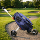 Foldable golf push trolley with a bag on the fairway