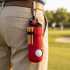 Golf tee and ball holder keychain clipped on the course