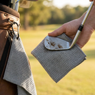Microfibre golf towel clipped to a bag on the course