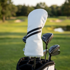 Striped headcover on a driver in a golf bag on the course